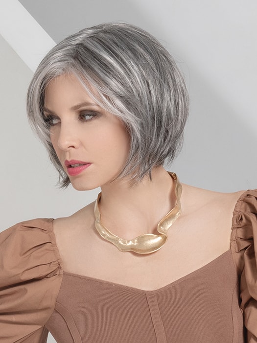 Wig style — silver-gray bob with gold necklace accent
