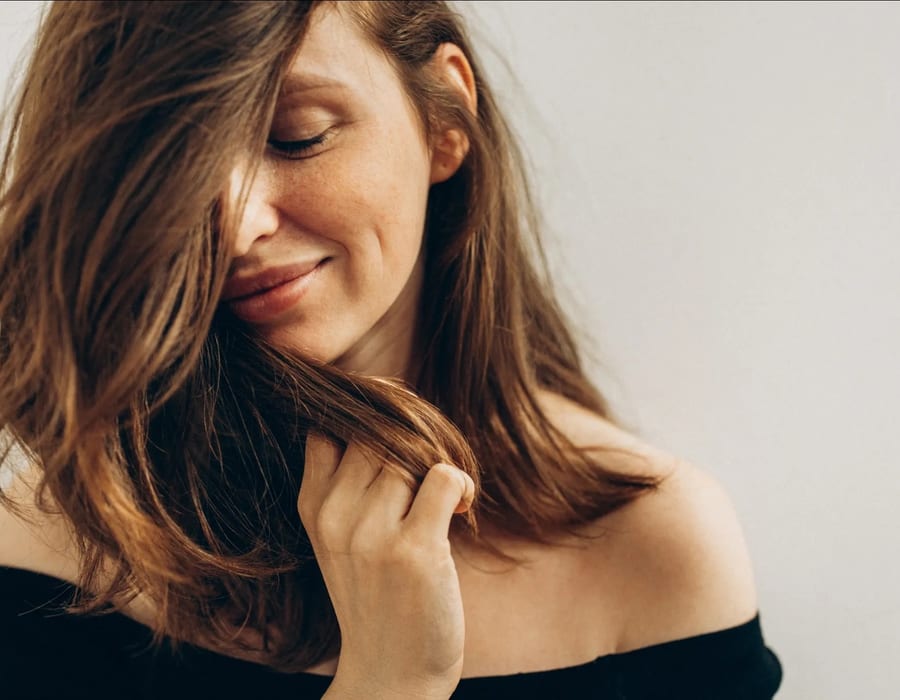 Woman with natural-looking hair volume in a salon